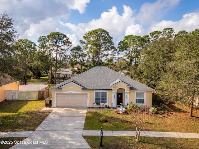 single story home featuring a garage and a front lawn