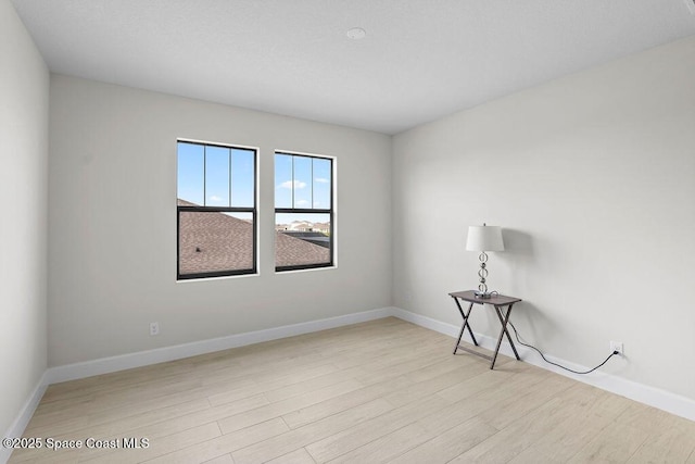 empty room with light hardwood / wood-style flooring