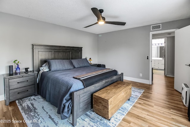 bedroom featuring ceiling fan, a textured ceiling, and light wood-type flooring