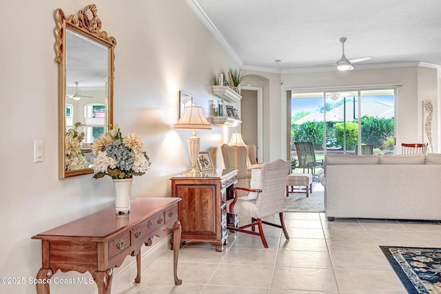 living area featuring a ceiling fan and crown molding