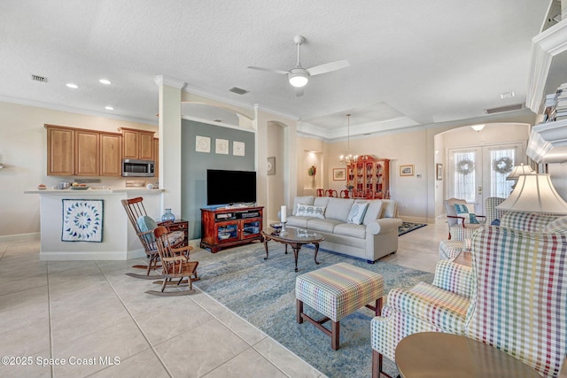 living room featuring visible vents, arched walkways, and light tile patterned flooring