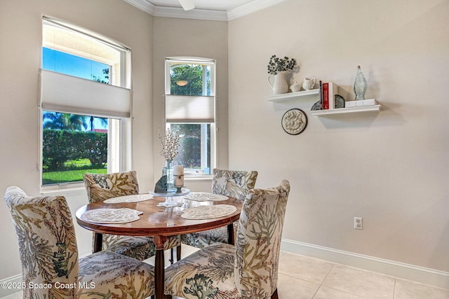 dining area with light tile patterned floors, baseboards, and crown molding