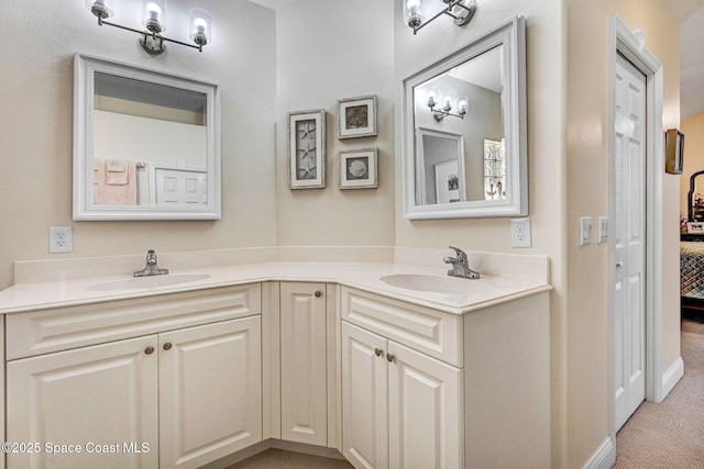 bathroom with double vanity, a sink, and ensuite bathroom