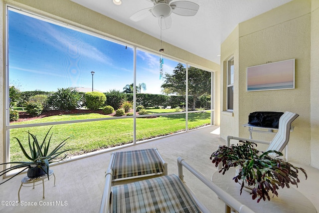 sunroom / solarium with a ceiling fan