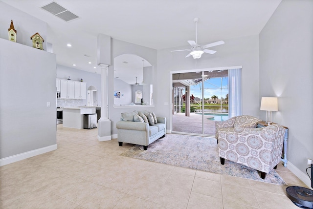 tiled living room featuring ceiling fan and sink