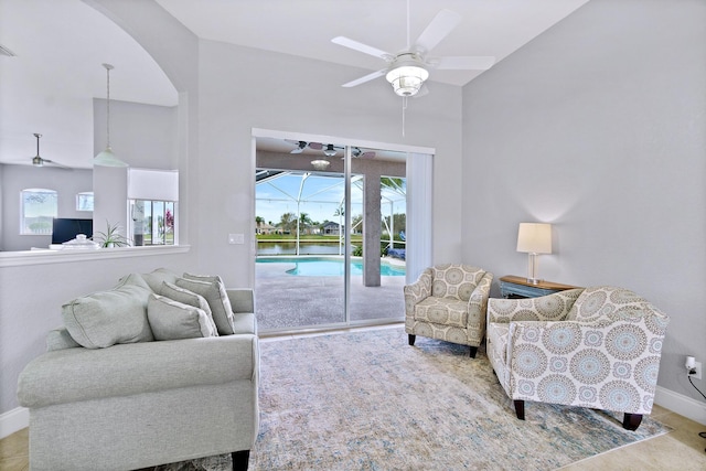 living room with ceiling fan and lofted ceiling