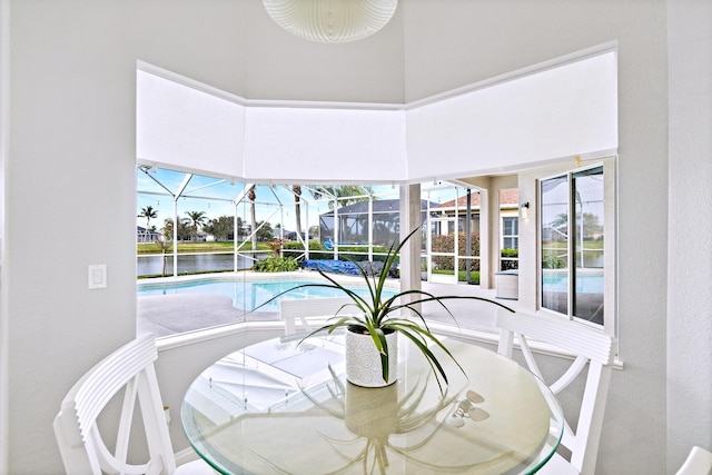 interior space featuring a water view and a high ceiling