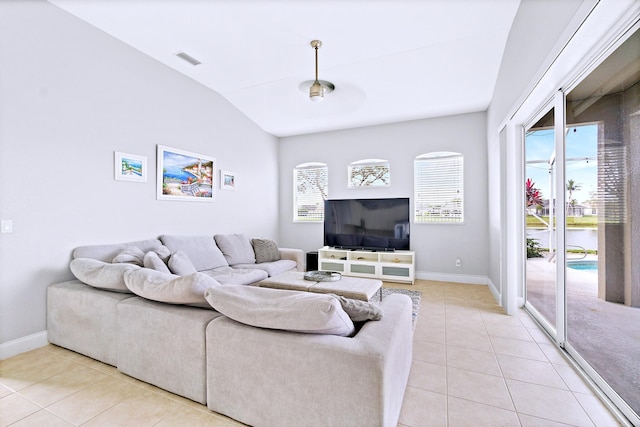 living room featuring vaulted ceiling and light tile patterned floors