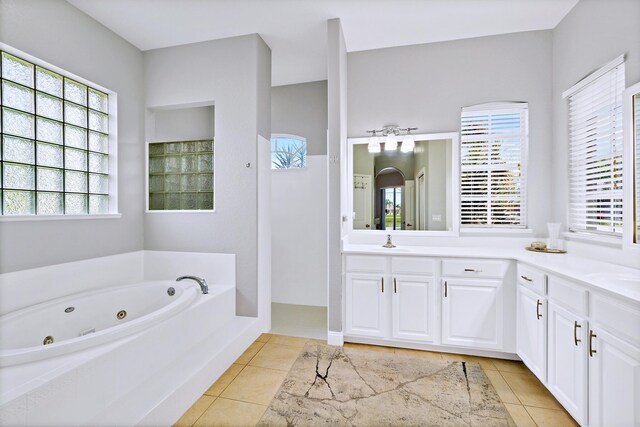 bathroom with vanity, tile patterned floors, and a tub