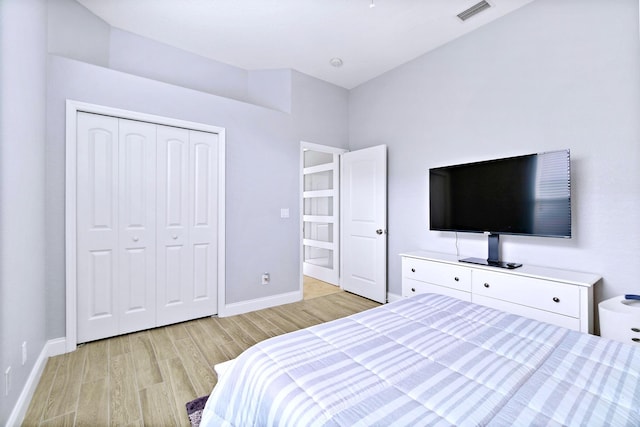 bedroom featuring light wood-type flooring and a closet