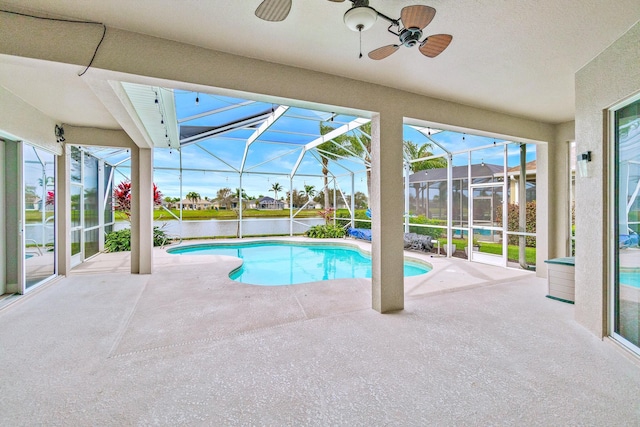 view of swimming pool featuring a water view, ceiling fan, a lanai, and a patio