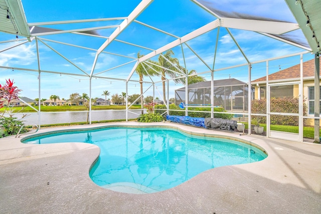 view of swimming pool with a water view, glass enclosure, and a patio area