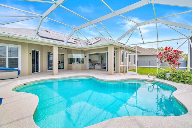 view of swimming pool featuring glass enclosure and a patio area