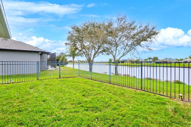 view of yard with a water view and a lanai