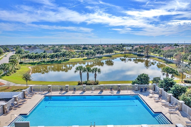 view of pool featuring a water view and a patio