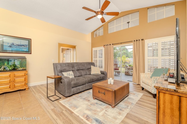 living room featuring high vaulted ceiling, ceiling fan, and light hardwood / wood-style flooring