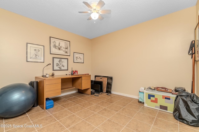 tiled office space featuring ceiling fan and a textured ceiling