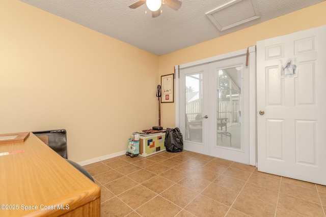 home office with tile patterned flooring, french doors, and a textured ceiling