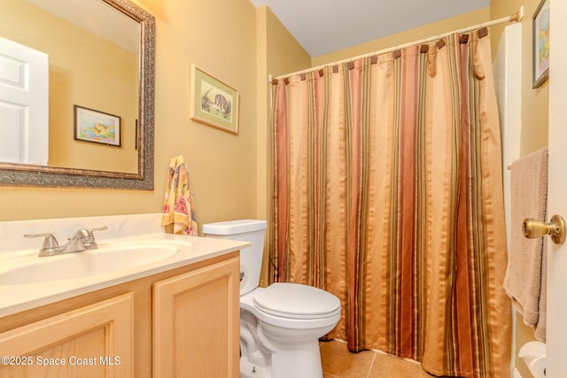 bathroom featuring vanity, tile patterned flooring, and toilet