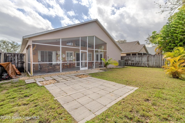 back of house with a patio area, a yard, a sunroom, and central AC unit