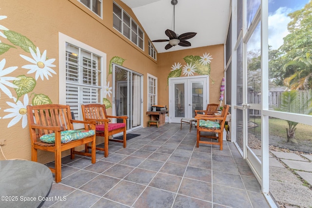 sunroom featuring ceiling fan and french doors