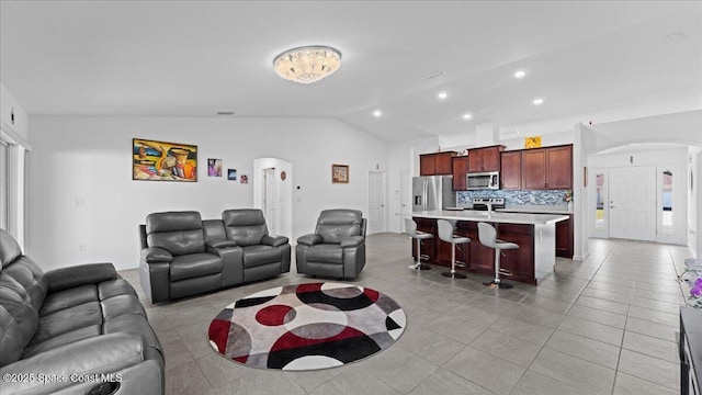 living room with light tile patterned flooring and lofted ceiling