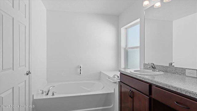 bathroom featuring vanity and a bath