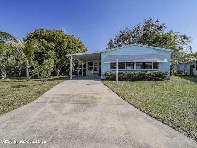 view of front of house with a front lawn and a carport