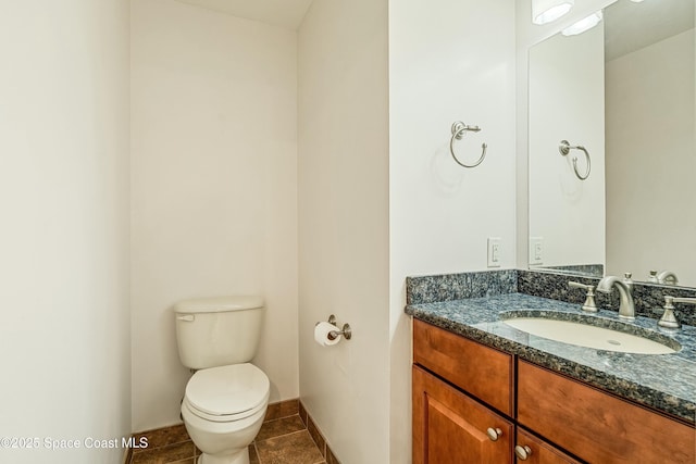 bathroom featuring tile patterned floors, vanity, and toilet