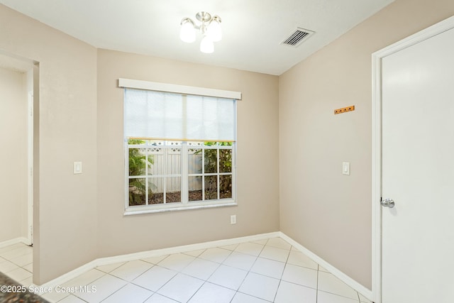 spare room featuring light tile patterned floors