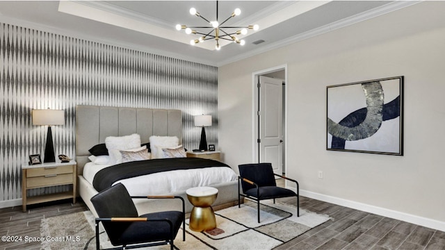 bedroom with crown molding, a raised ceiling, and a chandelier