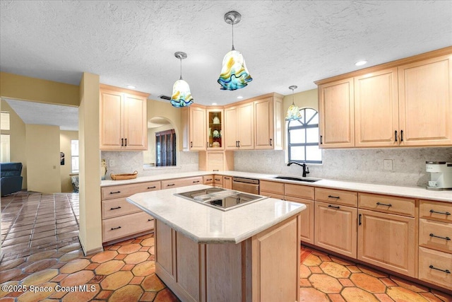 kitchen featuring sink, hanging light fixtures, black electric stovetop, a kitchen island, and light brown cabinets