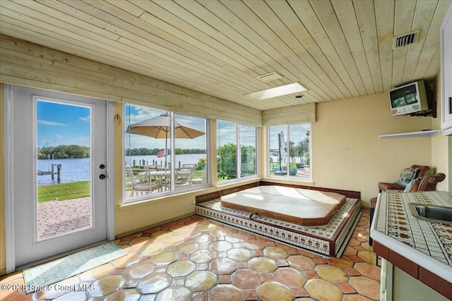 sunroom with a water view and wood ceiling