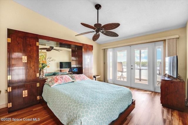 bedroom featuring dark wood-type flooring, access to outside, french doors, and vaulted ceiling