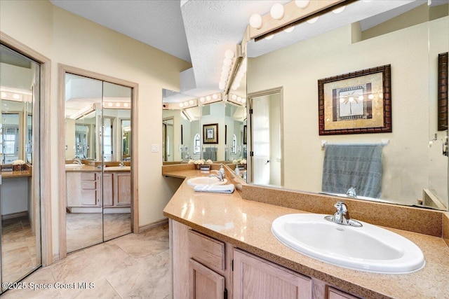 bathroom featuring vanity and a textured ceiling