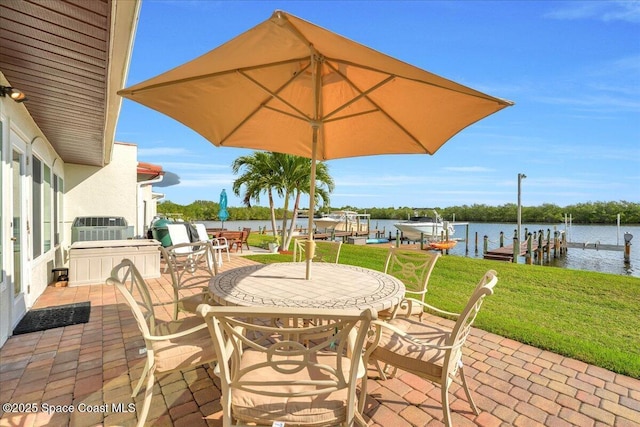 view of patio / terrace with a boat dock and a water view