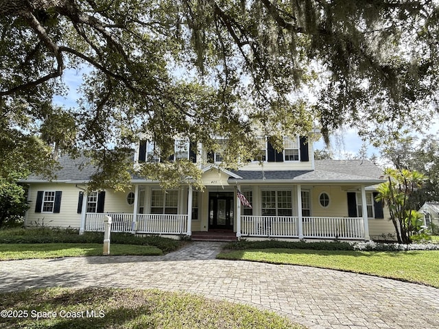 view of front of home with a front yard and covered porch