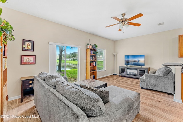 living room featuring ceiling fan and light wood-type flooring