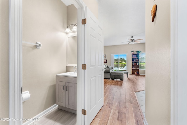 bathroom with hardwood / wood-style flooring, vanity, and ceiling fan