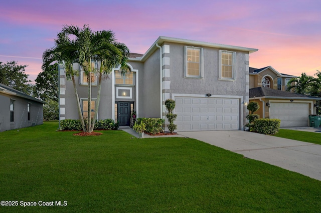 front of property featuring a garage and a lawn