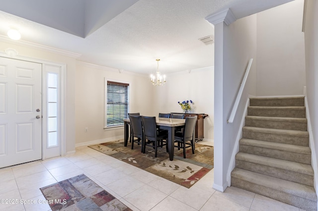 dining space featuring light tile patterned floors, a notable chandelier, and ornamental molding