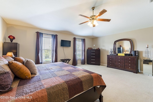 bedroom with light carpet and ceiling fan