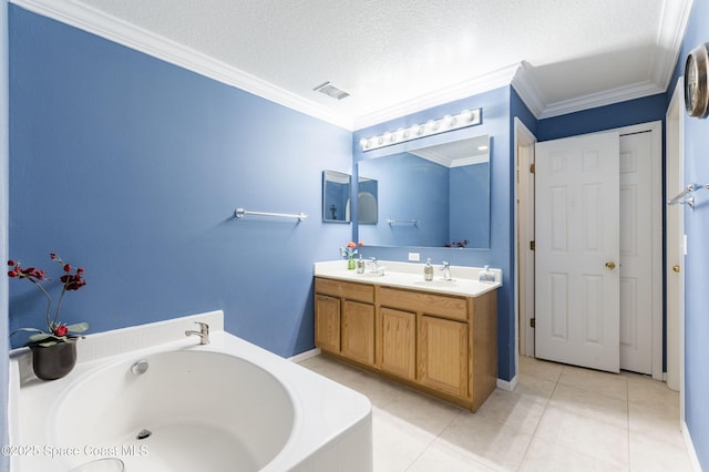 bathroom with a washtub, crown molding, vanity, a textured ceiling, and tile patterned floors