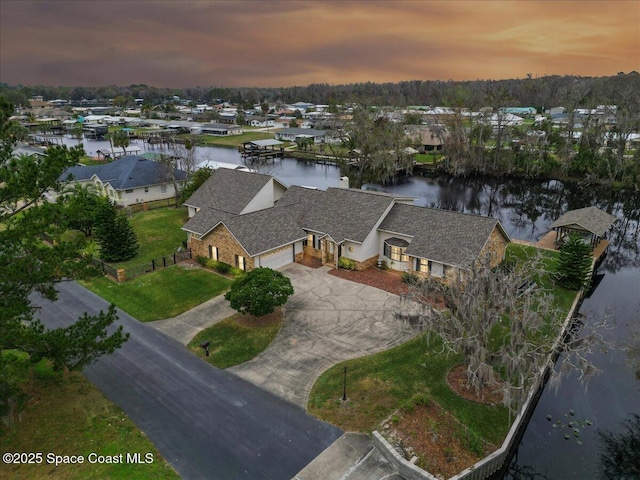 aerial view at dusk with a water view