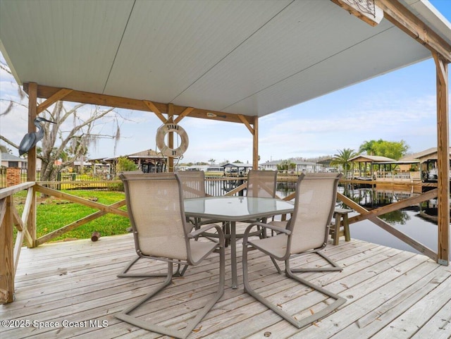 wooden terrace featuring a water view and a boat dock