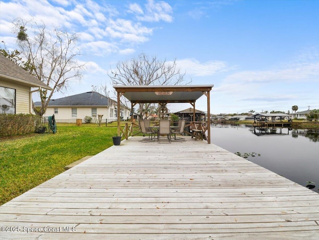 dock area featuring a water view and a lawn