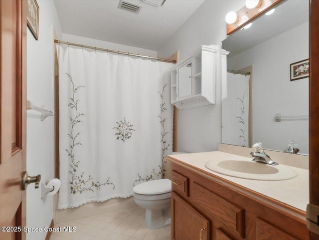 bathroom with tile patterned flooring, vanity, and toilet