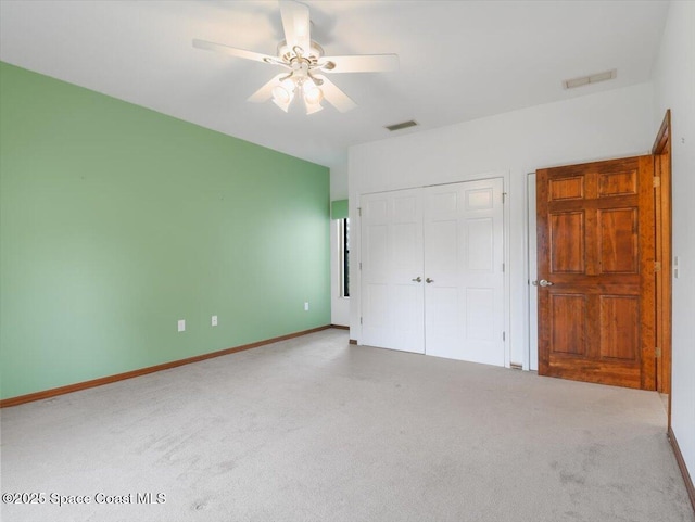 unfurnished bedroom with a closet, ceiling fan, and carpet