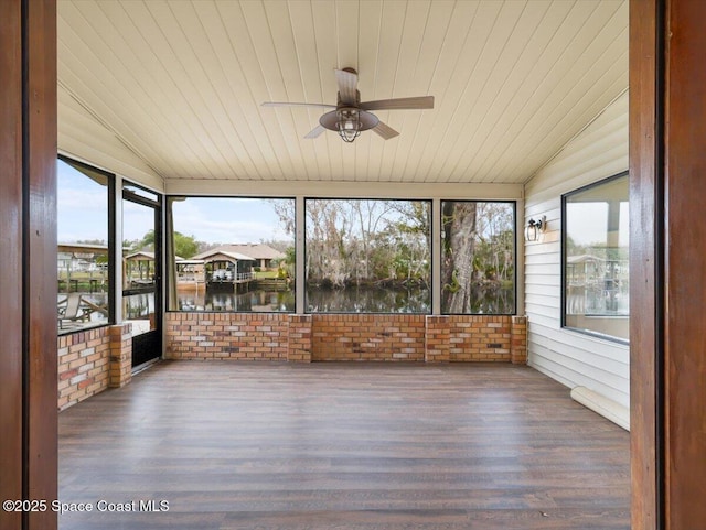 unfurnished sunroom featuring vaulted ceiling, a water view, wooden ceiling, and ceiling fan