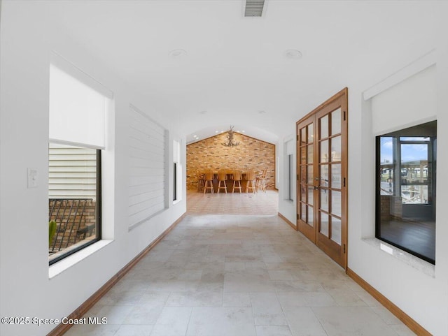 hallway featuring french doors and vaulted ceiling